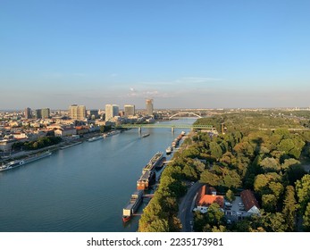 Panoramic, scenic view of Bratislava downtown and Danube river. Bulk carrier, cargo ship in river. Aerial view from famous UFO tower observation deck. Bratislava, Slovakia