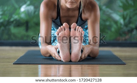 Similar – Image, Stock Photo Young woman stretching legs by sea pier