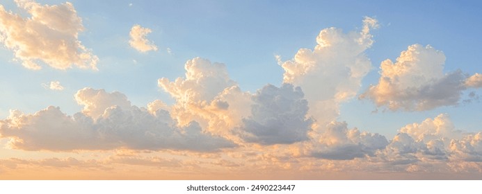 Panoramic serene sky with fluffy cumulus clouds during sunrise or sunset, warm orange blue gradient, peaceful day transition, expansive cloud formations, tranquil atmosphere - Powered by Shutterstock