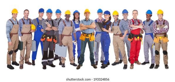 Panoramic shot of confident manual workers standing against white background