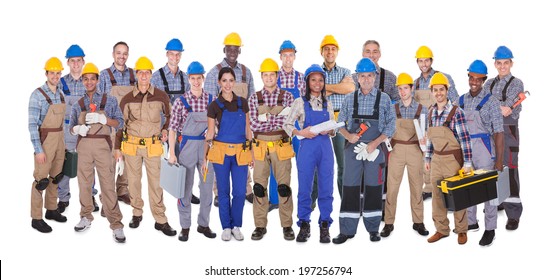 Panoramic shot of confident manual workers standing against white background