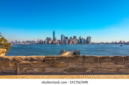 A Panoramic Shot Of New York City Near The Sea Under A Blue Sky