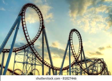 Panoramic shot of a roller coaster's loop at sunset.