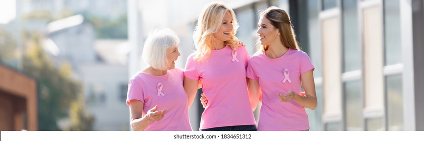 Panoramic shot of women with pink ribbons of breast cancer awareness outdoors - Powered by Shutterstock