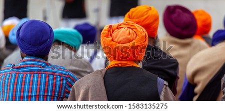 Panoramic of Sikh people from the back with their colory turban at the golden temple in amritsar, India