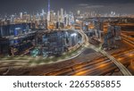 Panoramic skyline of Dubai with business bay and downtown with financial district night . Aerial view of many modern skyscrapers and busy traffic on al khail road. United Arab Emirates.