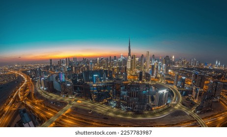 Panoramic skyline of Dubai with business bay and downtown district day to night timelapse. Aerial wide angle view of many modern skyscrapers with traffic on al khail road after sunset. - Powered by Shutterstock