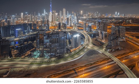 Panoramic skyline of Dubai with business bay and downtown with financial district night . Aerial view of many modern skyscrapers and busy traffic on al khail road. United Arab Emirates.