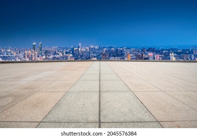 Panoramic skyline and empty square floor tiles with modern build