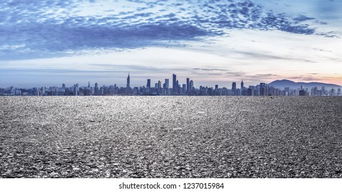 Panoramic skyline and modern buildings with empty road