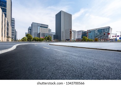 Panoramic skyline and modern business office buildings with empty road,empty concrete square floor - Shutterstock ID 1343700566