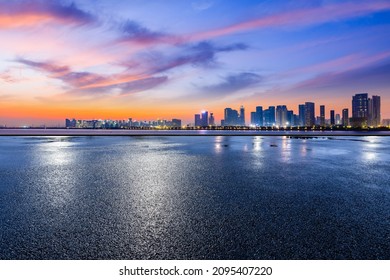 Panoramic skyline and modern commercial buildings with empty road. Asphalt road and cityscape at sunrise - Shutterstock ID 2095407220