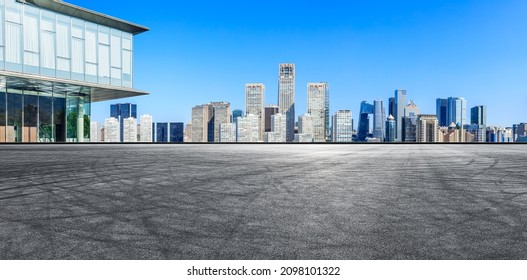 Panoramic skyline and modern commercial office buildings with empty road in Beijing, China.