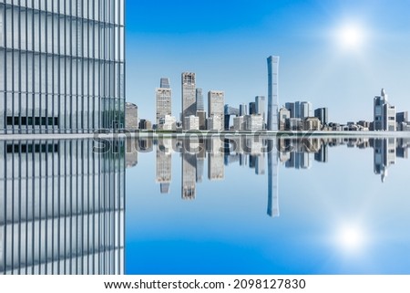 Panoramic skyline and modern commercial office buildings in Beijing. Cityscape and water reflection.