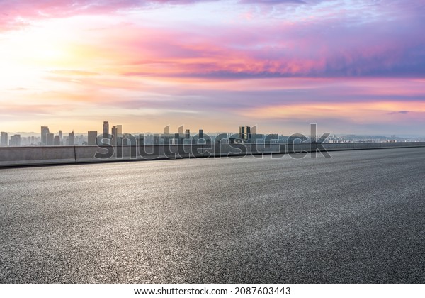 Panoramic skyline and modern\
commercial office buildings with empty road. Asphalt road and\
cityscape.