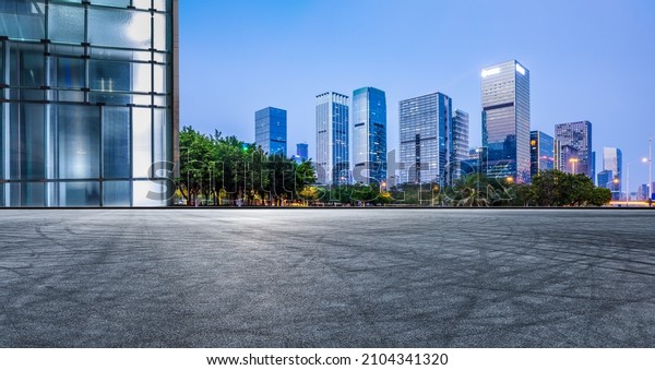 Panoramic\
skyline and modern commercial office buildings with empty road in\
Shenzhen, China. Asphalt road and\
cityscape.