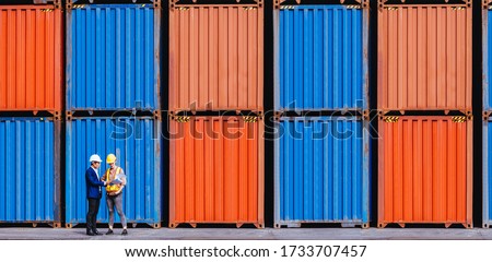 Panoramic of smart creative foreman and engineer woman control loading containers box from cargo freight ship for import export. Logistic, transportation, import and export concept. With copy space.