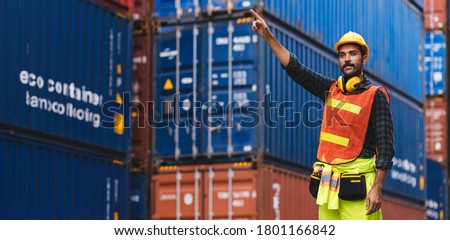 Panoramic smart creative foreman engineer man control loading containers box from cargo freight ship for import export. Logistic, transportation, import and export concept with copy space.