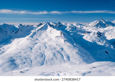 Panoramic Snow Covered Mountain Range Under Blue Sky