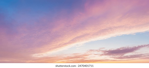 Panoramic Sunset Sky with Gradient Colors from Blue to Purple, Fluffy Clouds at Dusk, Warm Pink Sunset Glow, Tranquil Evening Cloud Formation, Picturesque Twilight Panorama - Powered by Shutterstock