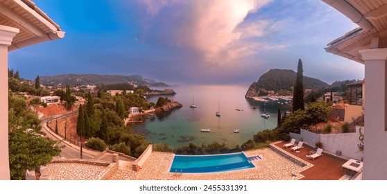 Panoramic sunset view of Paleokastritsa Bay and pool terrace at dusk on Corfu Island, Greece - Powered by Shutterstock