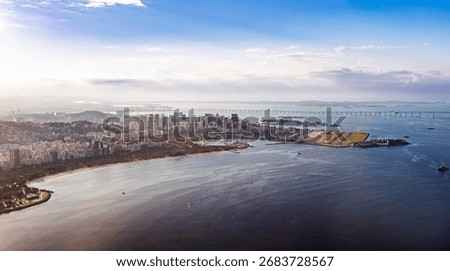 Panoramic sunset view of Rio de Janeiro's central coastline, Guanabara Bay, and Santos Dumont Airport runway extending into the water. Rio de Janeiro Brazil.
