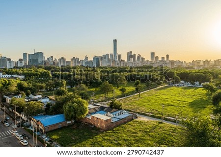 A panoramic sunset view of the skyline in the core area of Beijing's CBD, comparing the old and new urban development.