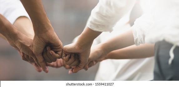 Panoramic teamwork business join hand together concept, Business team standing hands together, Volunteer charity work. People joining for cooperation success business. - Shutterstock ID 1559411027