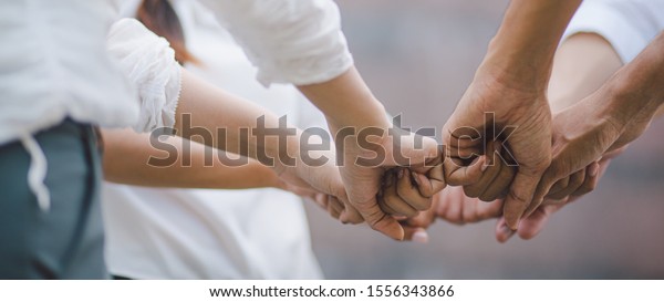 Panoramic teamwork business\
join hand together concept, Business team standing hands together,\
Volunteer charity work. People joining for cooperation success\
business.