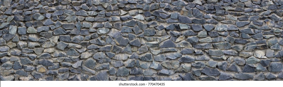 Panoramic texture of gray stonewall