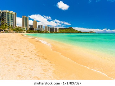 panoramic tropical sunny day view of the world famous and iconic Waikiki Beach in Honolulu, Hawaii on the island of Oahu - turquoise pacific ocean and the Waikiki skyline - Powered by Shutterstock