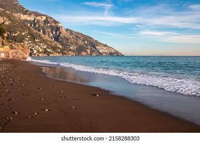 Panoramic twilight view at Fornillo Beach in town Positano, Amalfi Coast, Italy, Campania, Europe. Luxury vacation Tyrrhenian, Mediterranean Sea. Early evening sunbeam reflection in sand. No people - Shutterstock ID 2158288303
