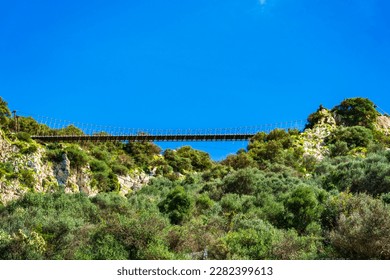 Panoramic view of the 70m-long pedestrian Windsor Bridge - a suspension bridge on the Upper Rock in Gibraltar
