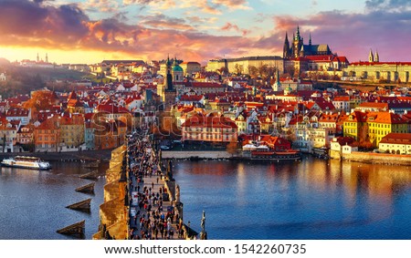 Panoramic view above at Charles Bridge Prague Castle and river Vltava Prague Czech Republic. Picturesque landscape with sunset old town houses with red tegular roofs and broach tower.