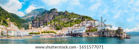 Panoramic view, aerial skyline of small haven of Amalfi village with tiny beach and colorful houses, located on rock, Amalfi coast, Salerno, Campania, Italy