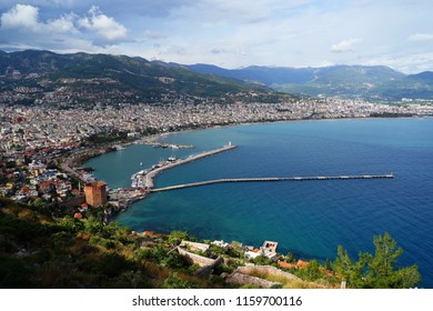Panoramic view of Alanya ancient harbor, city wall, red tower and coastline, Turkey