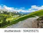 Panoramic view of Alps mountains in summer. Great view of beautiful landscape. Blue sky with clouds, green meadows, tourists on hiking trails. Nassfeld, Hermagor. Carinthia. Austria.