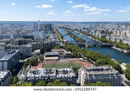 Panoramic view of Émile Anthoine Stadium, the roofs of the buildings around the Tour Eiffel and Seine river, Paris, France.