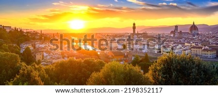 Panoramic view of Arno river, with Ponte Vecchio, Palazzo Vecchio and Cathedral of Santa Maria del Fiore during sunset, Florence, Italy