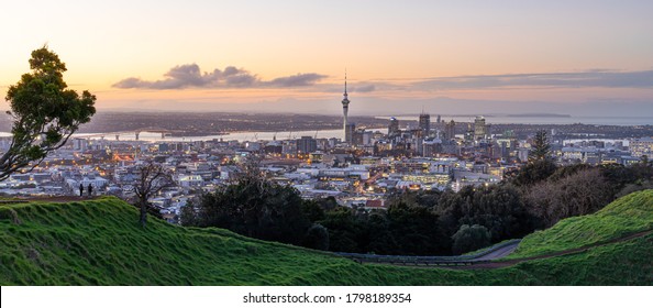 Panoramic view of Auckland city skyline with Auckland Sky Tower from Mt. Eden at sunset New Zealand