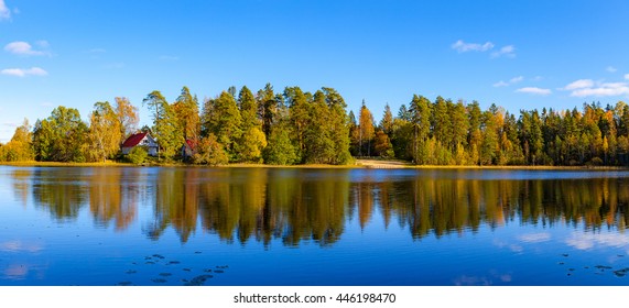 Panoramic view of autumn forest and houses reflection in pond, Aegviidu, Estonia - Powered by Shutterstock