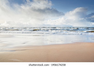 Panoramic view of Baltic sea from sandy shore (sand dunes). Dramatic sky with glowing clouds, sunbeams. Waves, water splashes. Idyllic seascape. Warm winter weather, climate change, nature. Denmark - Powered by Shutterstock