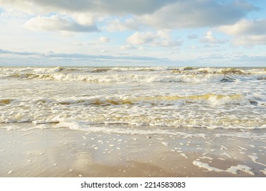 Panoramic View Of The Baltic Sea From A Sandy Shore (sand Dunes). Clear Sky With Glowing Clouds, Waves And Water Splashes. Idyllic Seascape. Warm Winter Weather, Climate Change, Nature