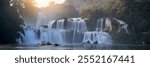 Panoramic View of Ban Gioc Waterfalls at Sunset, Vietnam – Majestic Cascades in Lush Forest Setting, Ideal for Nature and Travel Themes.Unesco site.