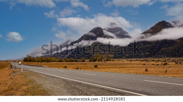 Panoramic view of Banner of traveling on the\
road with mountain range near Aoraki Mount Cook and the road\
leading to Mount Cook Village in New\
zealand	