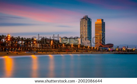Panoramic view of a Barcelona beach at sunset