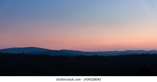 Panoramic view of beautiful gradient sky over the mountains at sunset.