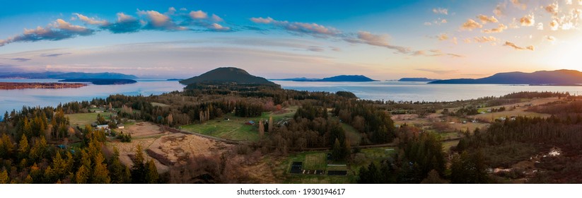 Panoramic View Of A Beautiful Island Sunset In The Pacific Northwest. Aerial Shot Of Lummi Island Located In The Salish Sea Area Of The San Juan Islands, Washington State During A Winter Sunset.