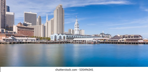 Panoramic view of beautiful San Francisco skyline with historic Ferry Building at famous Embarcadero street on a sunny day with blue sky and clouds in summer, California, USA