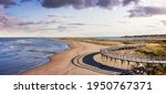 Panoramic view of a beautiful sandy beach on the Atlantic Ocean Coast. Sunset Sky Art Render. Taken in La Dune de Bouctouche, New Brunswick, Canada.